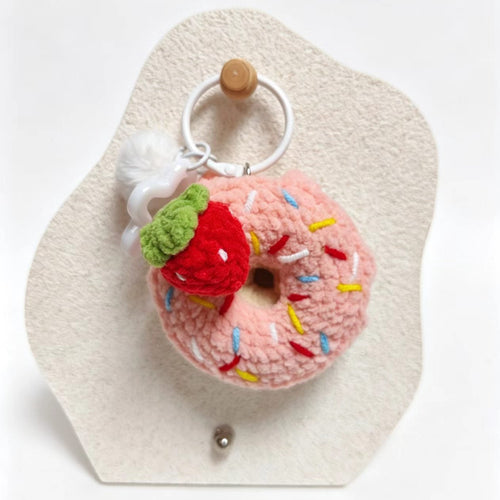 Crocheted donut keychain with strawberry on a white background